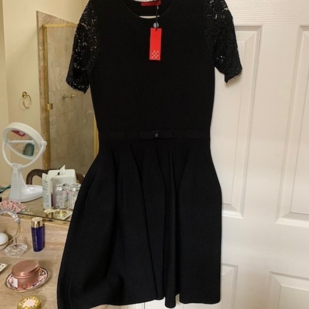 Carolina Herrera LBD with lace sleeves and CH belt